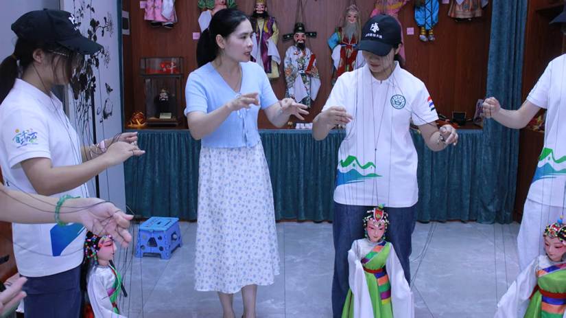 图2：传承人李伟平调整队员们的握线手型